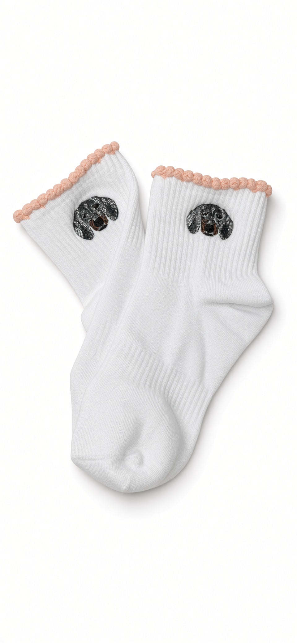 White cotton socks with a dapple dachshund embroidered on the cuffs